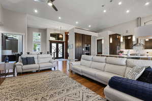 Open-concept living space featuring wood-finish flooring, recessed lighting, and a ceiling fan