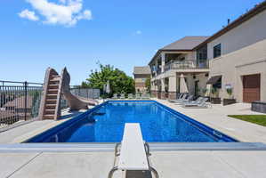 Rectangular in-ground pool with a diving board and attached slide