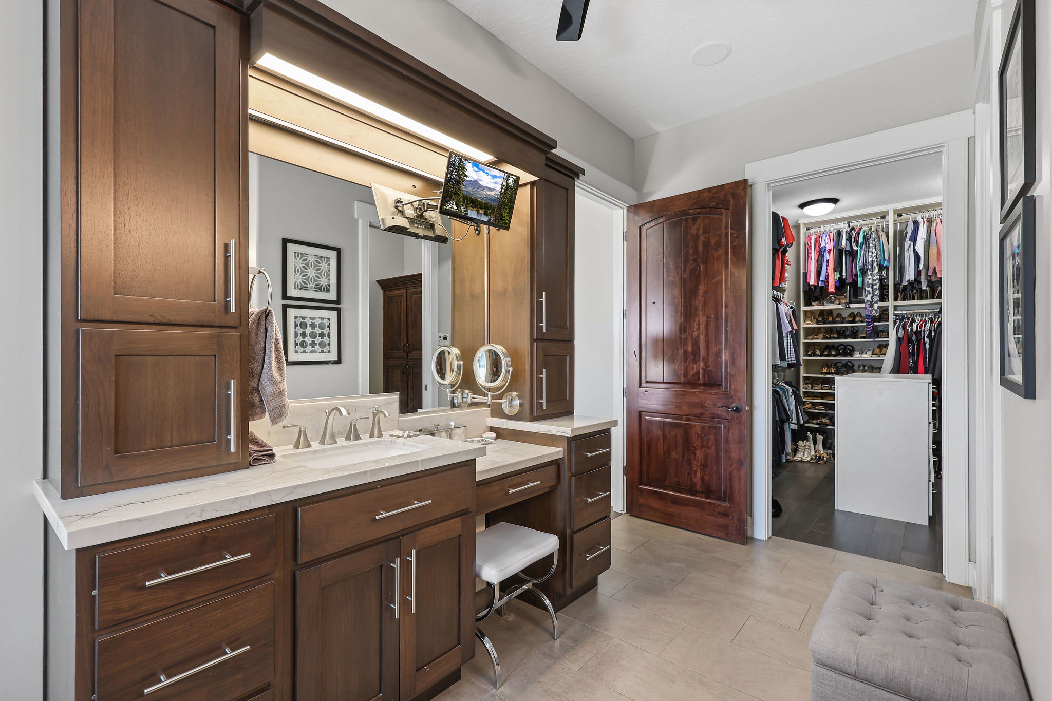 Bathroom vanity featuring dark wood cabinetry, a light-toned countertop, and dual sinks
