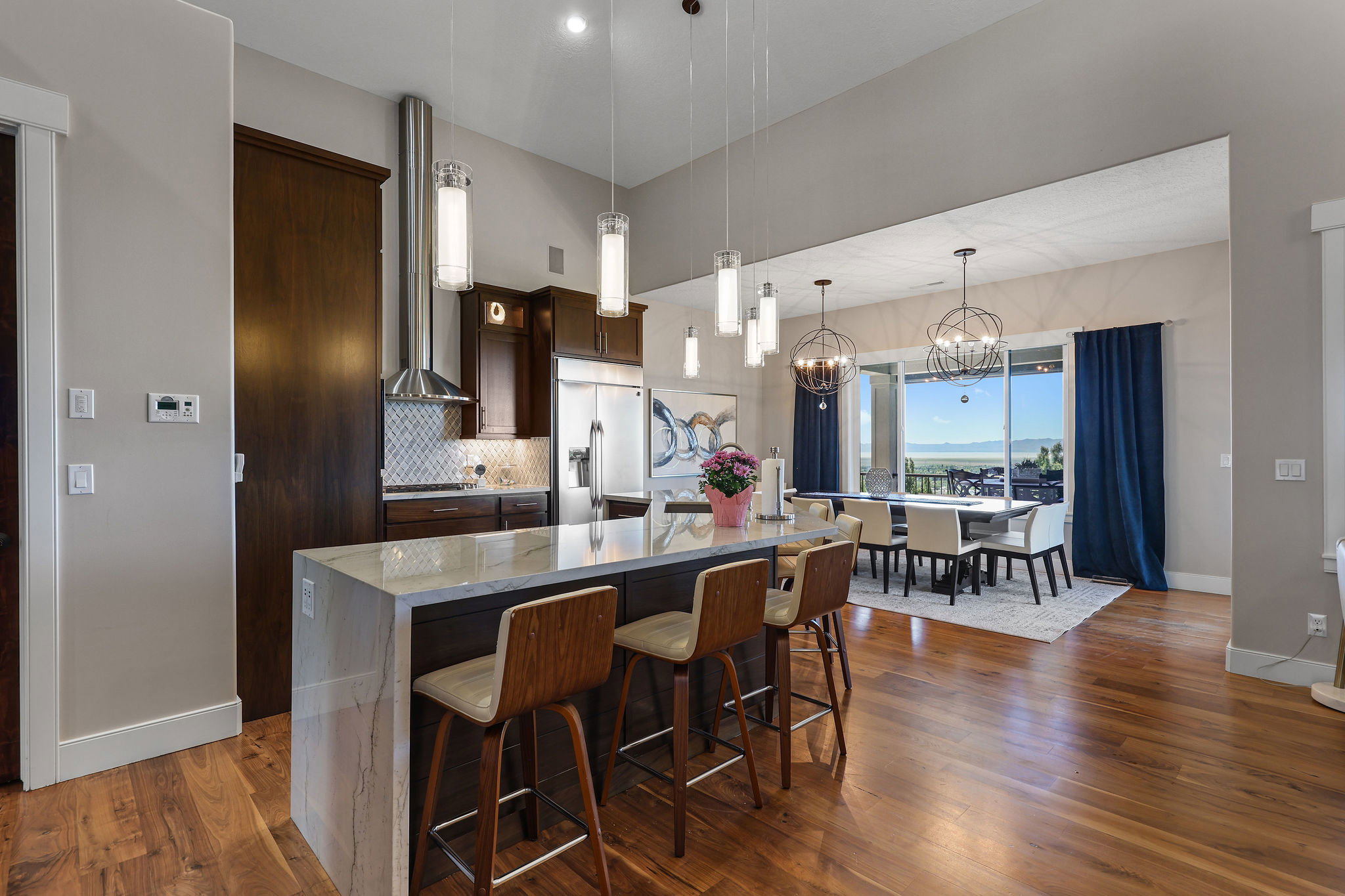 Open-concept kitchen and dining area featuring rich wood-finish flooring