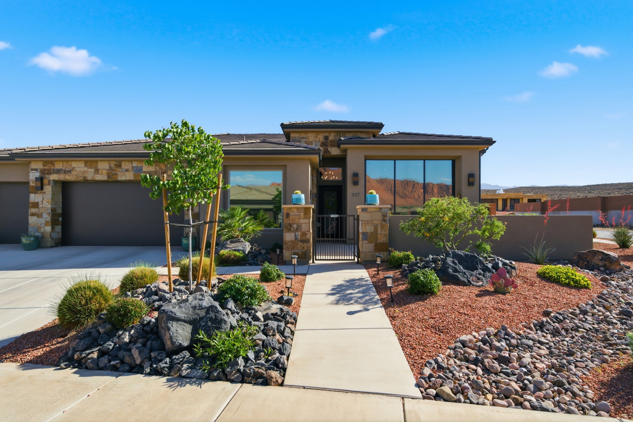 Modern stucco exterior with stone accents and a tile roof
