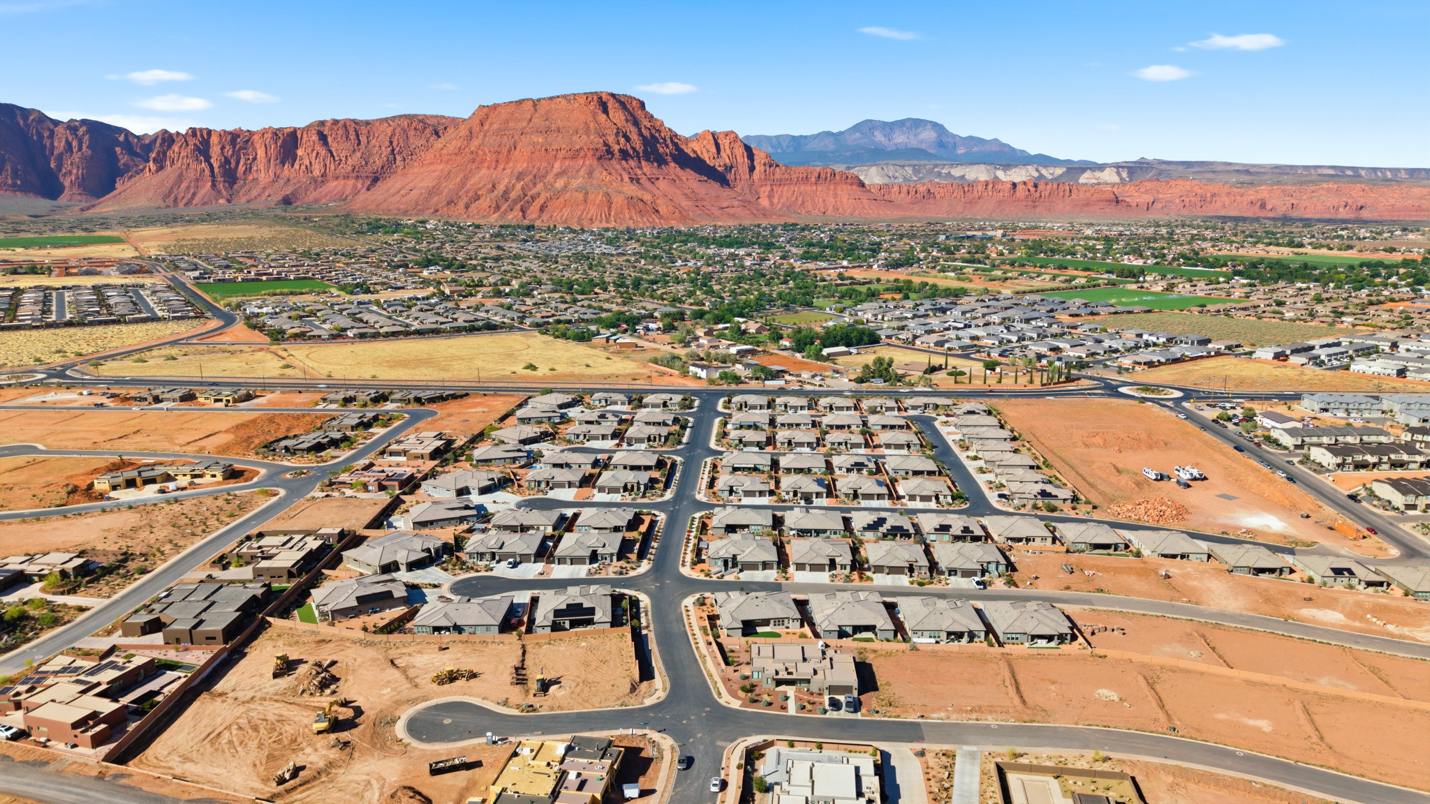 Expansive residential development featuring numerous single-story properties with gray roofing and paved street infrastructure