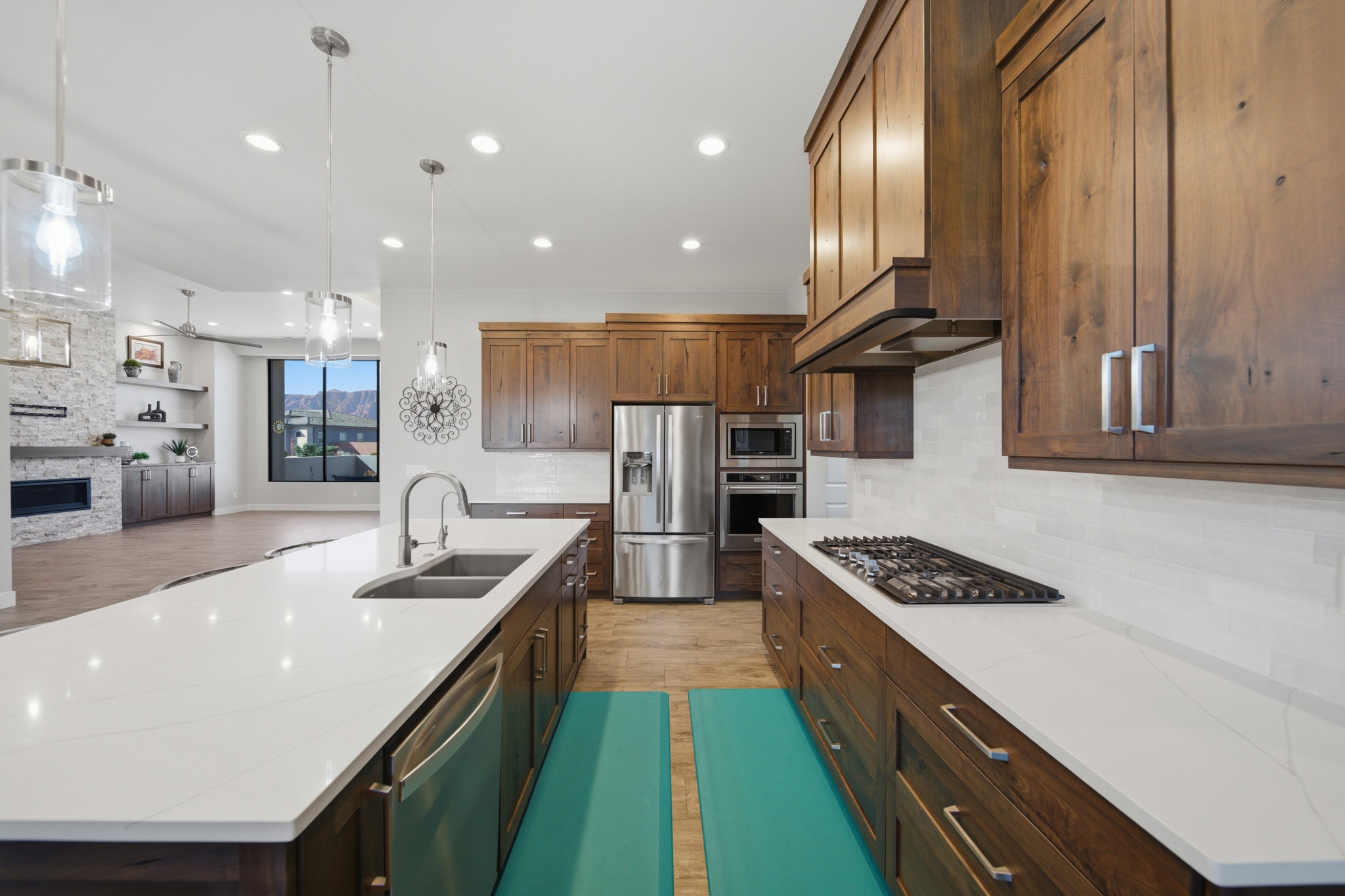 Expansive kitchen island with white countertop and integrated double basin sink