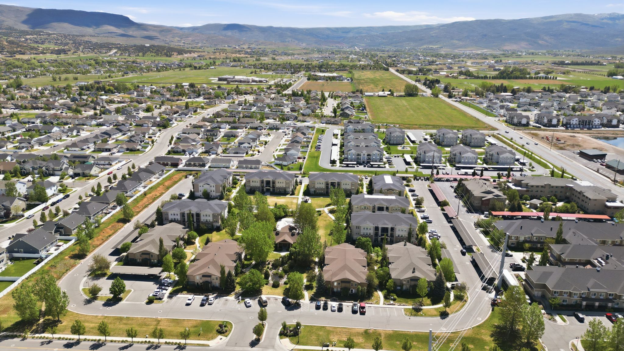 Expansive residential development featuring a mix of single-family homes and multi-story apartment buildings