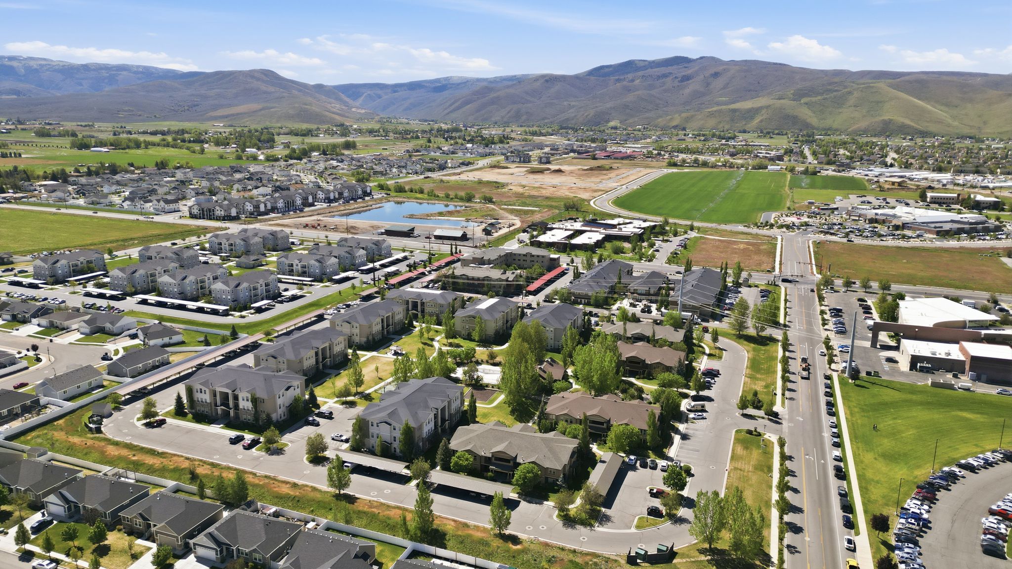 Expansive aerial perspective showcasing a residential and commercial development within a valley setting