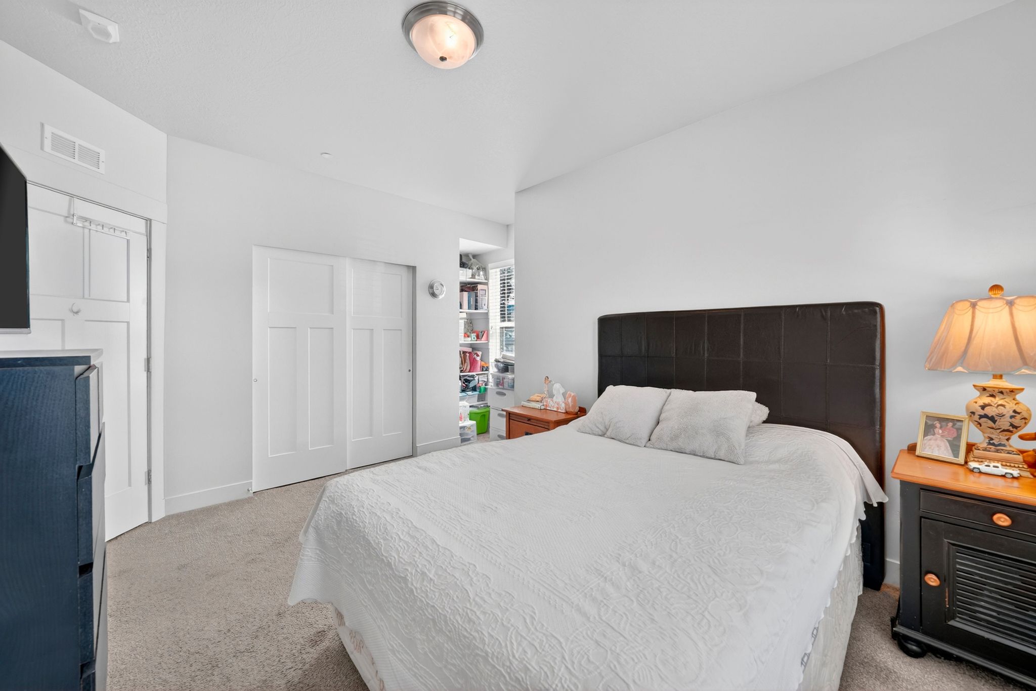 Carpeted room featuring white walls, a flush-mount ceiling light fixture, and white trim