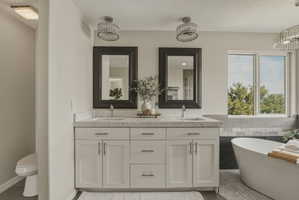 Dual vanity with stone countertop, undermount sinks, and framed mirrors