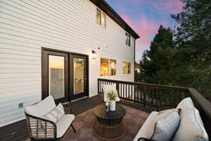 Expansive outdoor deck featuring dark wood-finish flooring and railing