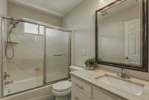 Bathroom featuring a white vanity with an integrated sink and light-toned countertop