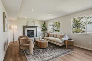 Living area featuring recessed lighting, wood-finish flooring, and multiple windows