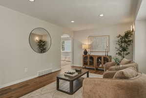 Living area featuring recessed lighting, wood-finish flooring, and light-toned walls