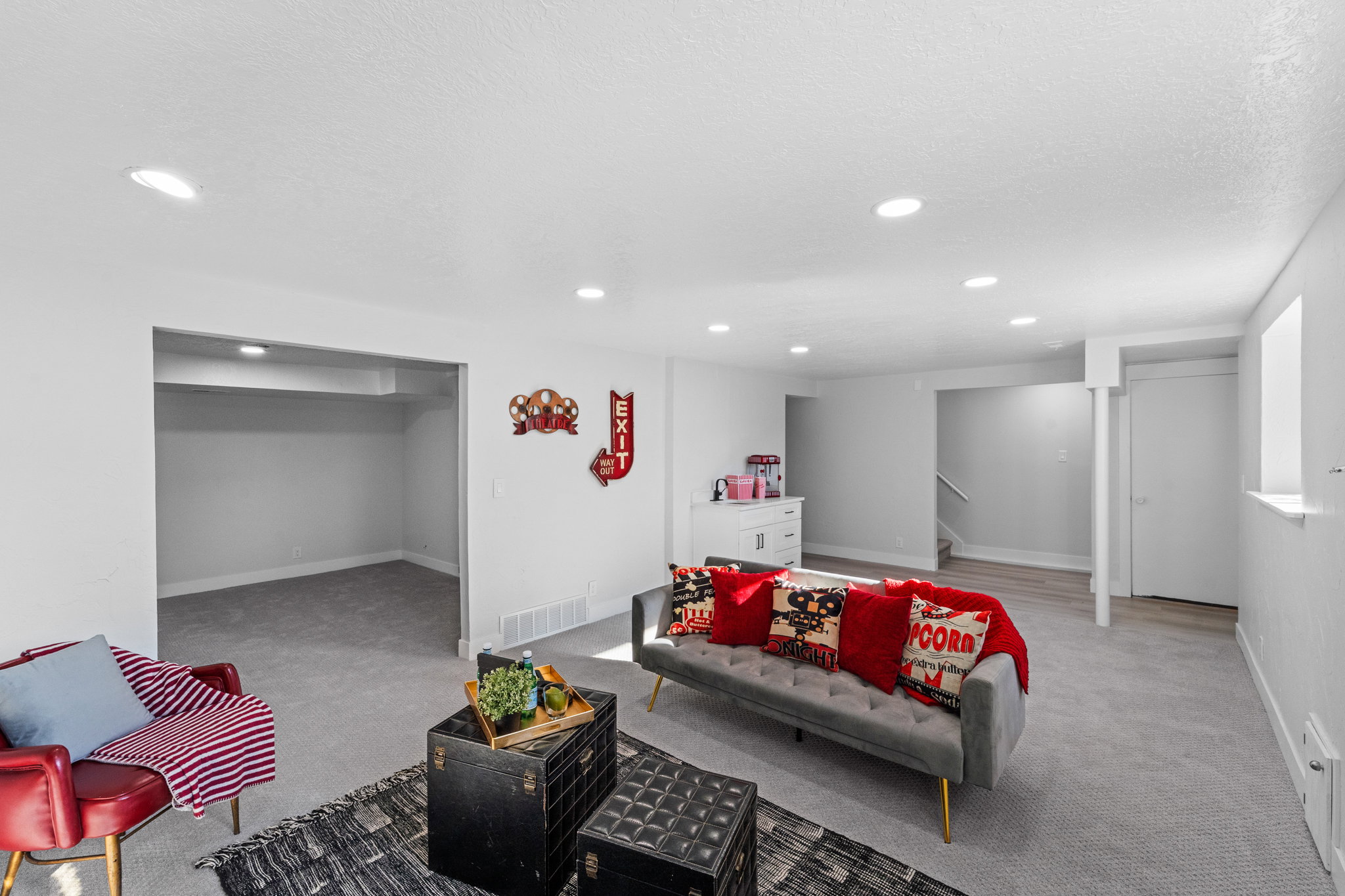 Spacious finished basement featuring recessed lighting, a neutral color palette, and a combination of carpeting and wood-finish flooring