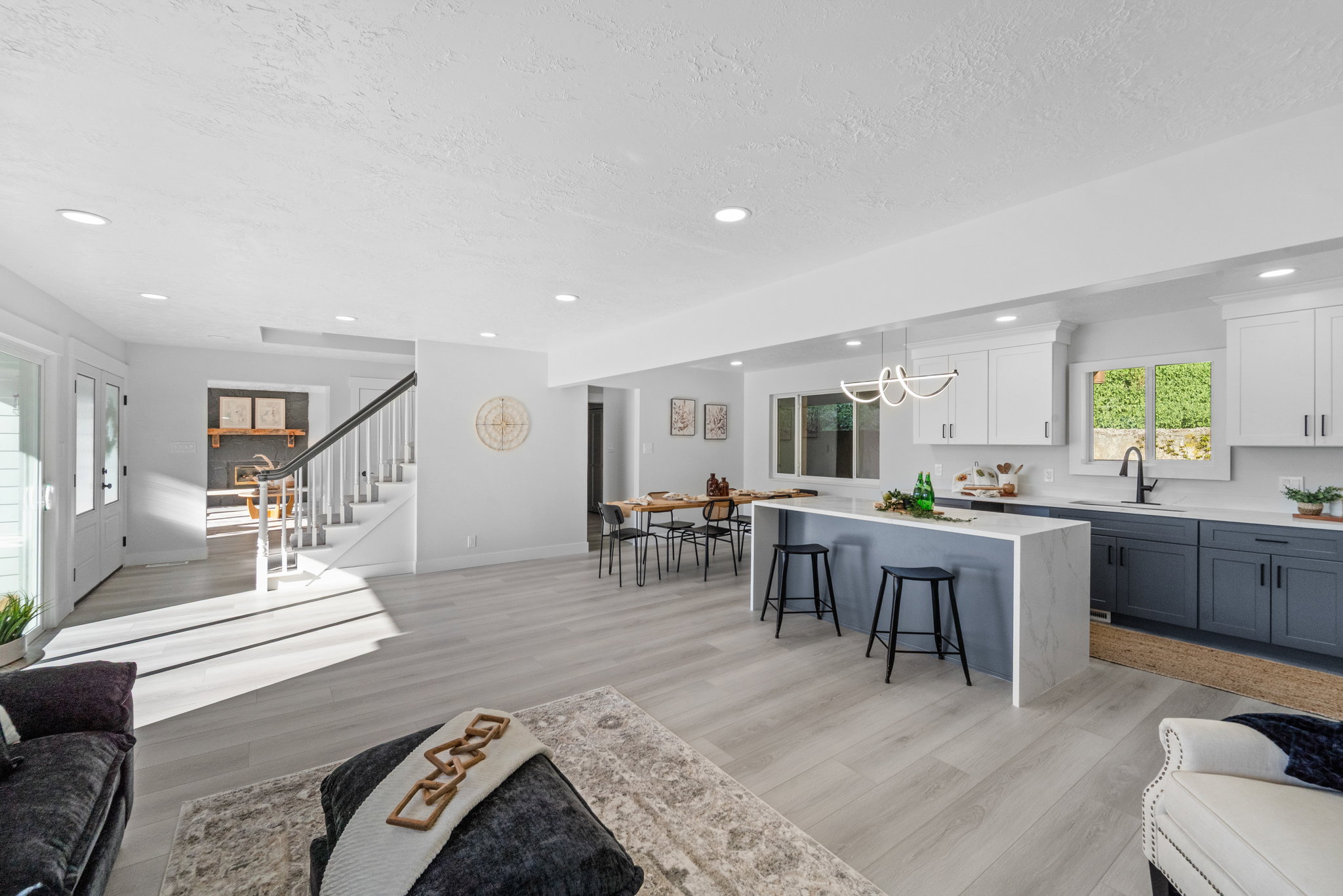 Open-concept living space with light wood-finish flooring