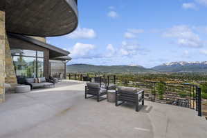 Spacious outdoor patio with stone facade and dark wood paneling