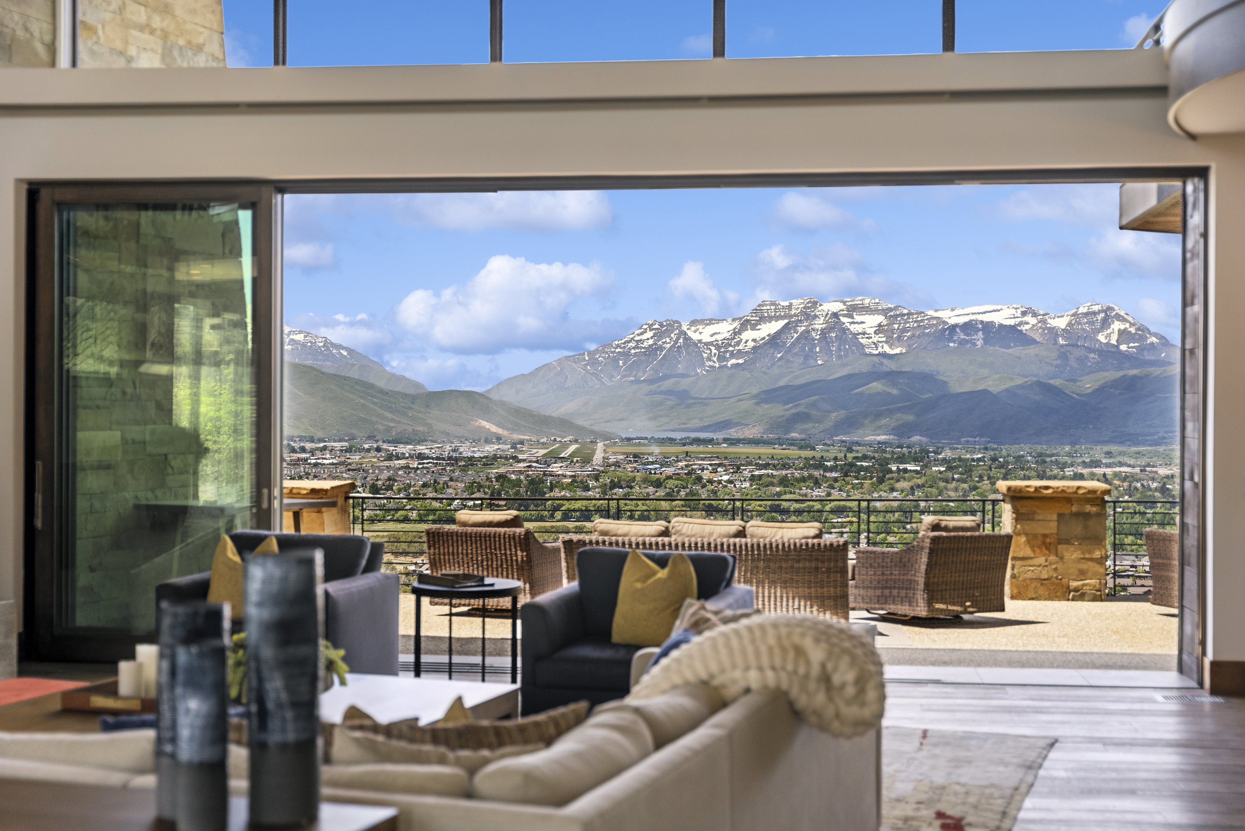 Expansive sliding glass doors opening to a large outdoor deck