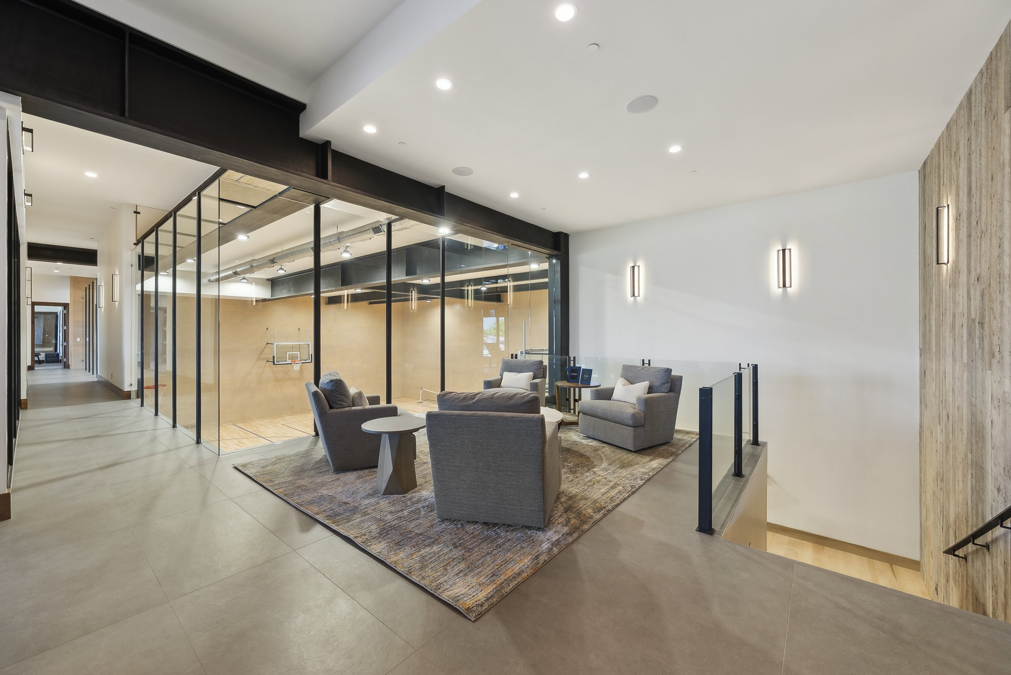 Interior recreation space featuring a full-sized court behind glass walls