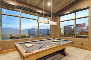 Reclaimed wood-finish vaulted ceiling with recessed lighting