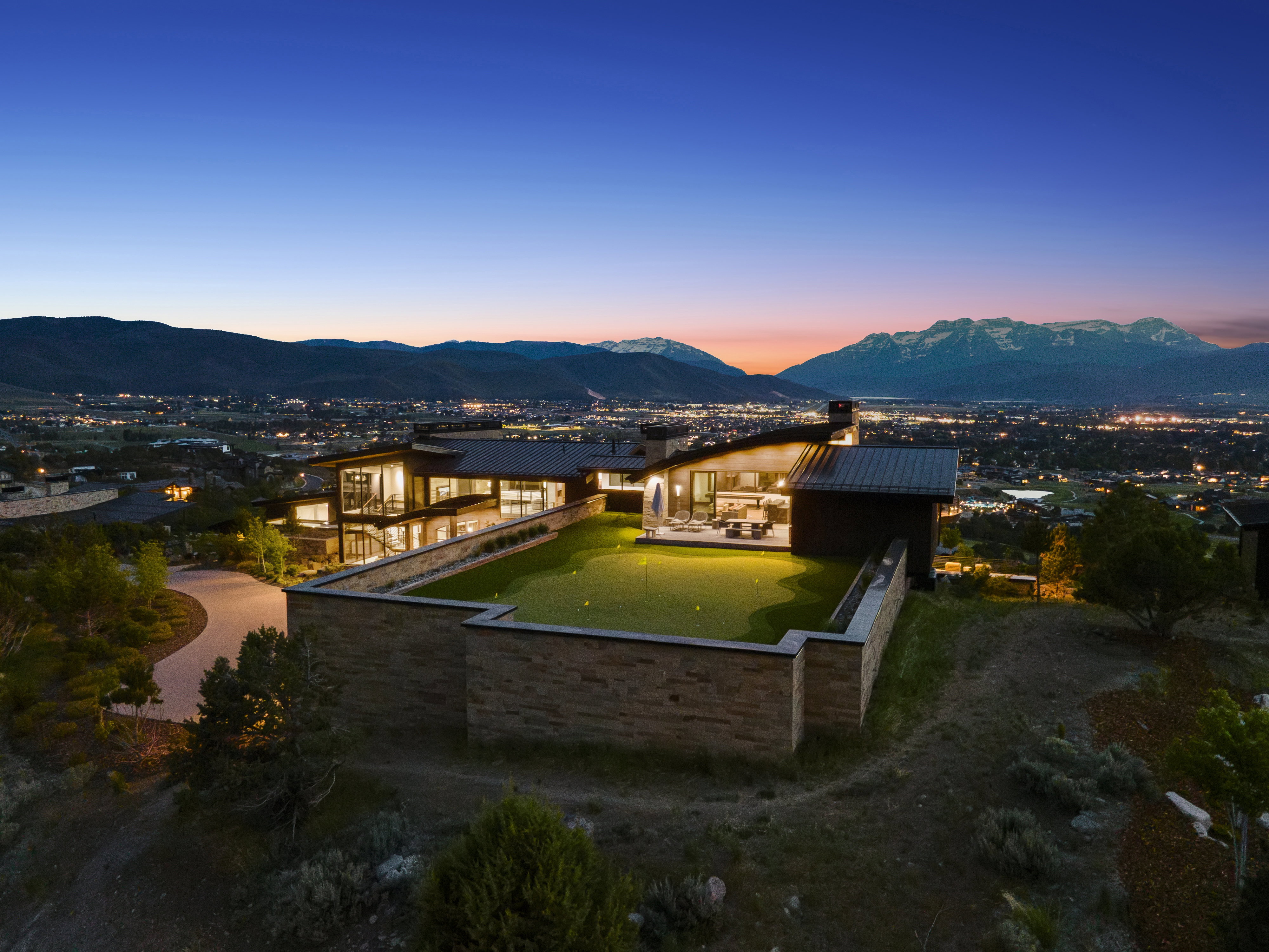 Contemporary architectural design featuring extensive glazing and a stone-clad exterior