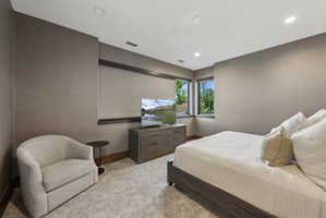 Spacious room featuring textured wall coverings, recessed lighting, and large windows with natural scenery