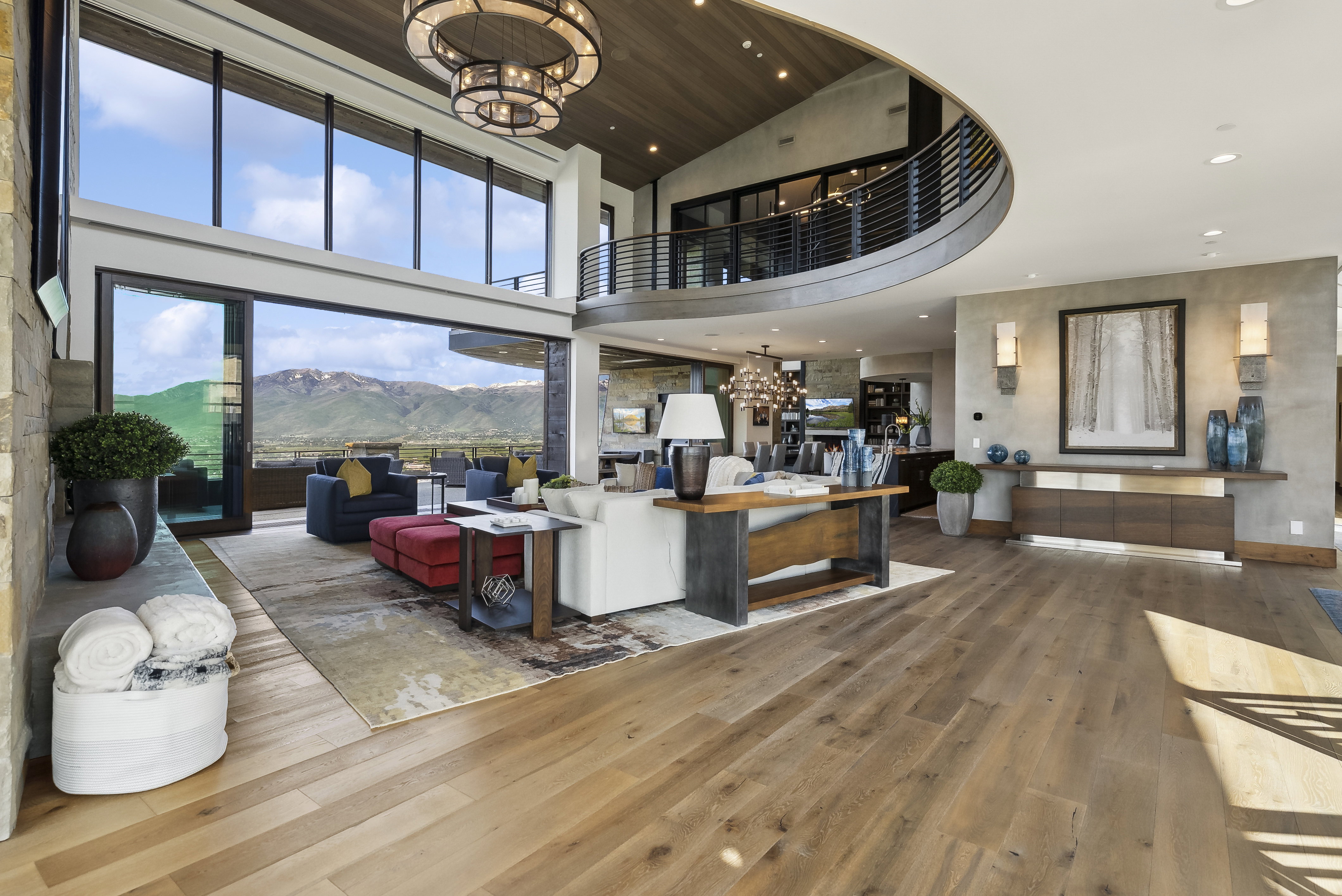 Open-concept living space featuring high ceilings and wood-finish flooring