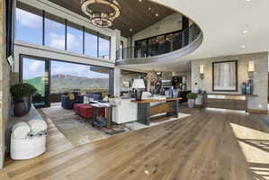 Open-concept living space featuring high ceilings and wood-finish flooring