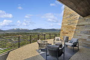Terrace featuring a stone accent wall, wood-paneled ceiling, and a gravel-textured floor