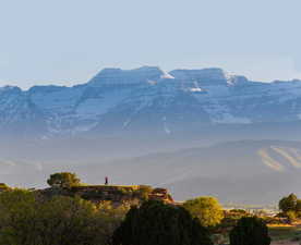 Expansive mountain backdrop featuring snow-capped peaks and distant valleys