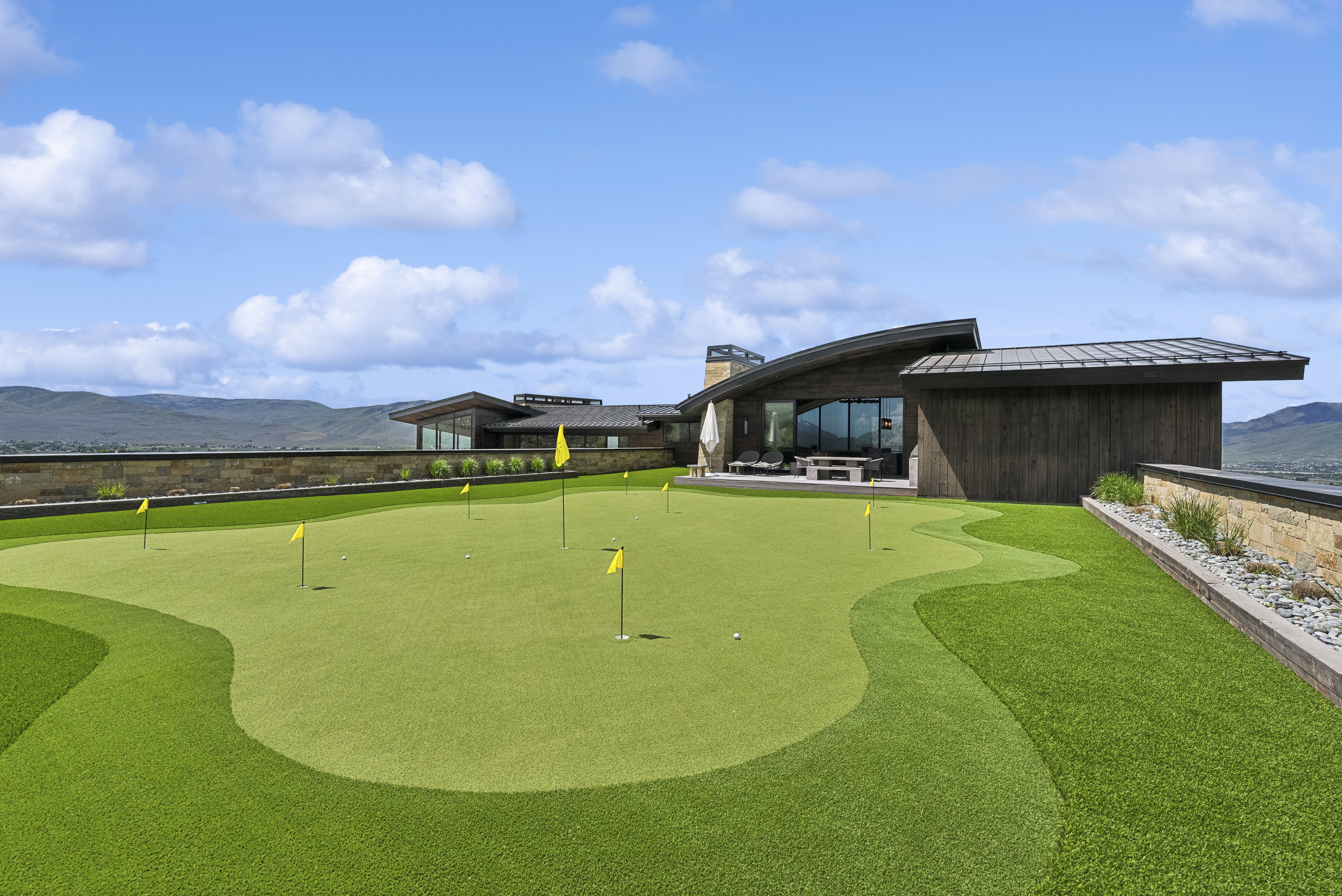 Expansive putting green with multiple flag positions and artificial turf