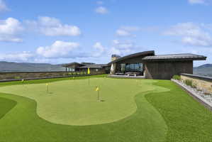 Expansive putting green with multiple flag positions and artificial turf