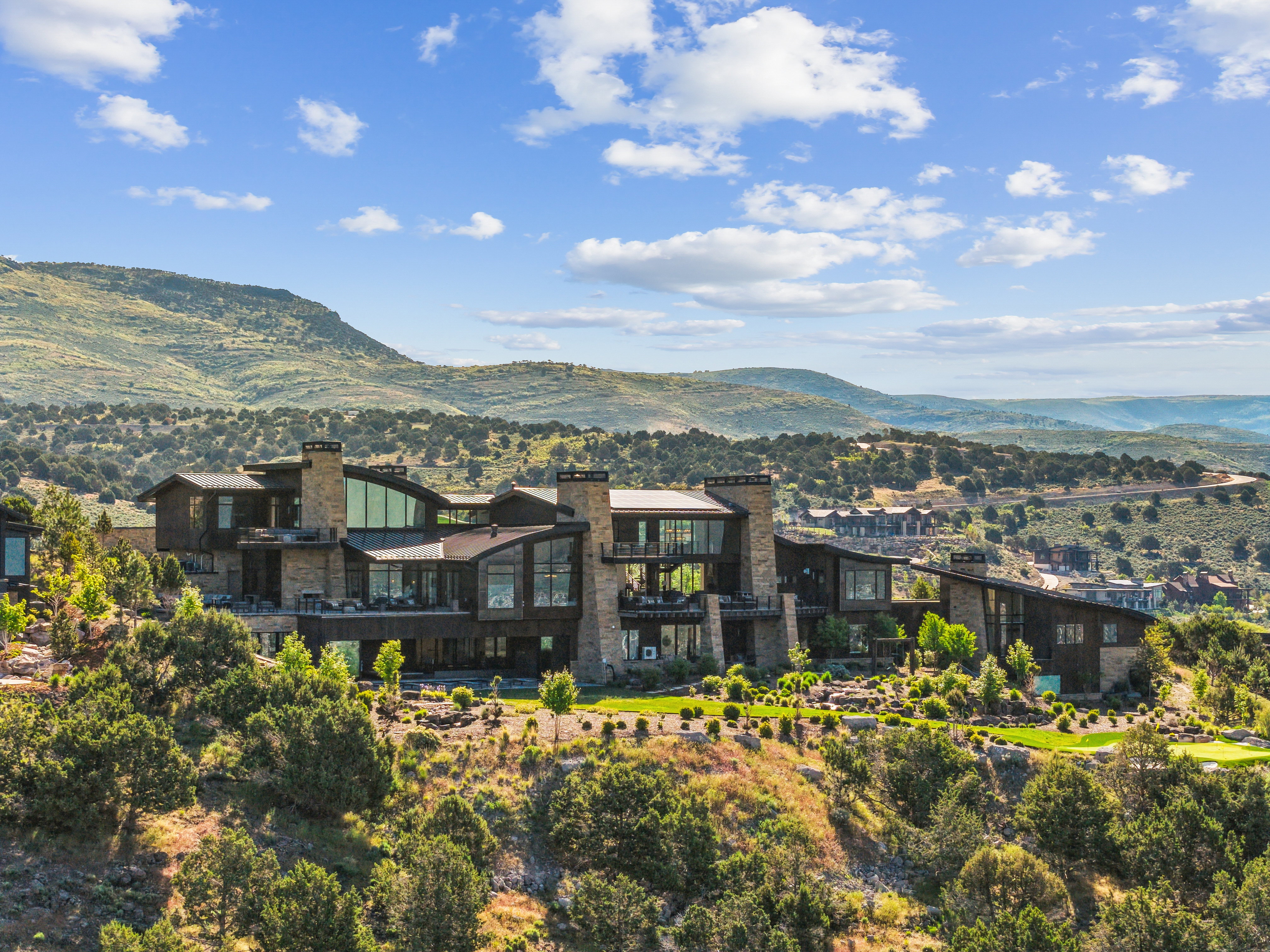 Expansive multi-level residence featuring stone and dark wood exterior