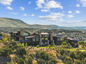 Expansive multi-level residence featuring stone and dark wood exterior