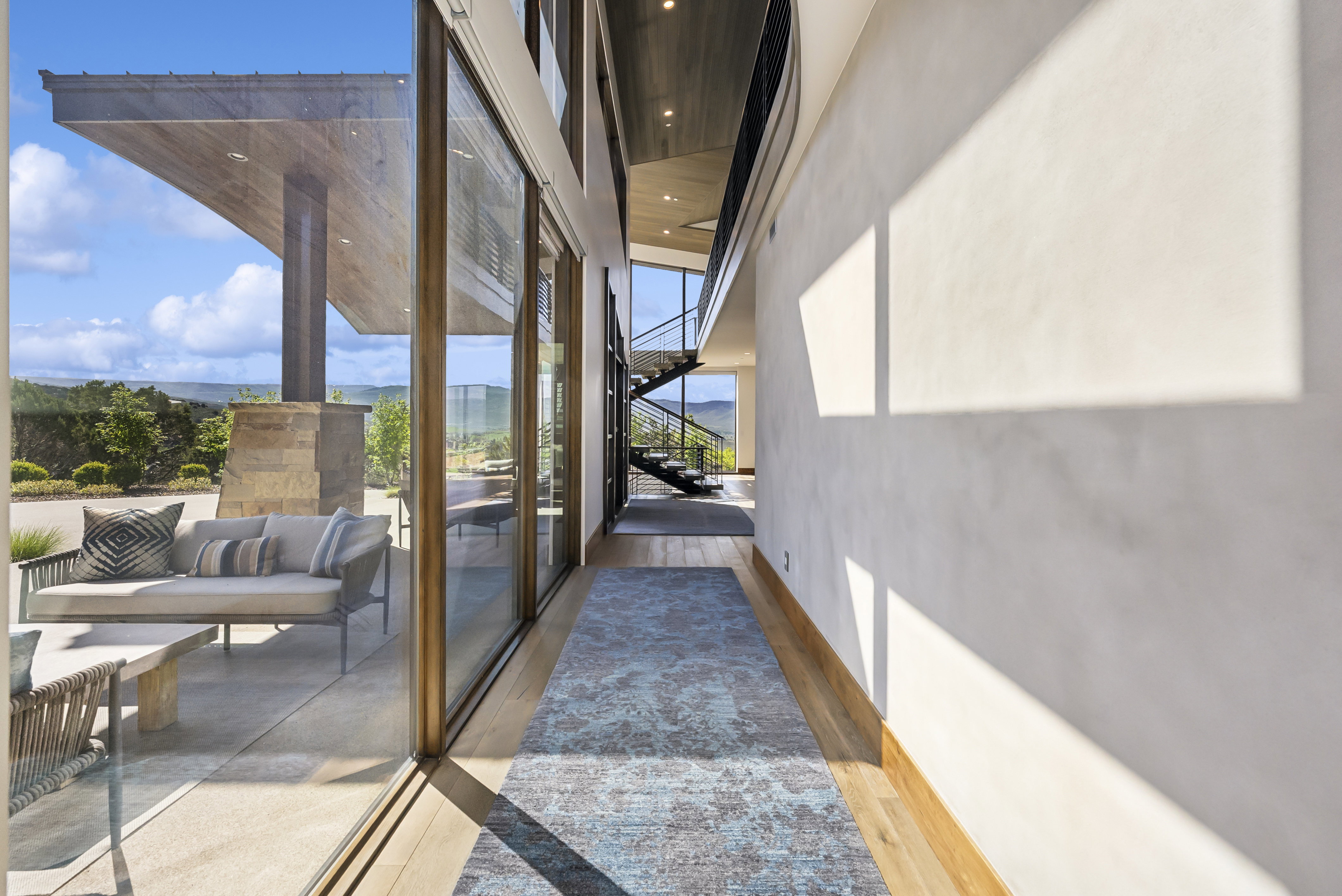 Expansive glass sliding doors provide natural light and outdoor access