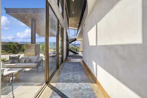 Expansive glass sliding doors provide natural light and outdoor access