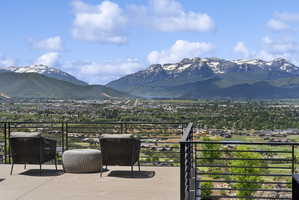 Expansive outdoor patio with a concrete surface and a black horizontal bar railing system