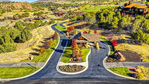 Gated community entrance featuring a timber and stone archway