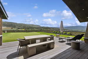 Expansive outdoor patio featuring composite decking and a built-in putting green