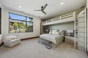 Spacious room featuring a full-wall window, built-in bunk beds, recessed lighting, and a modern ceiling fan