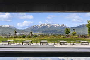 Expansive mountain scenery framing a contemporary outdoor living space