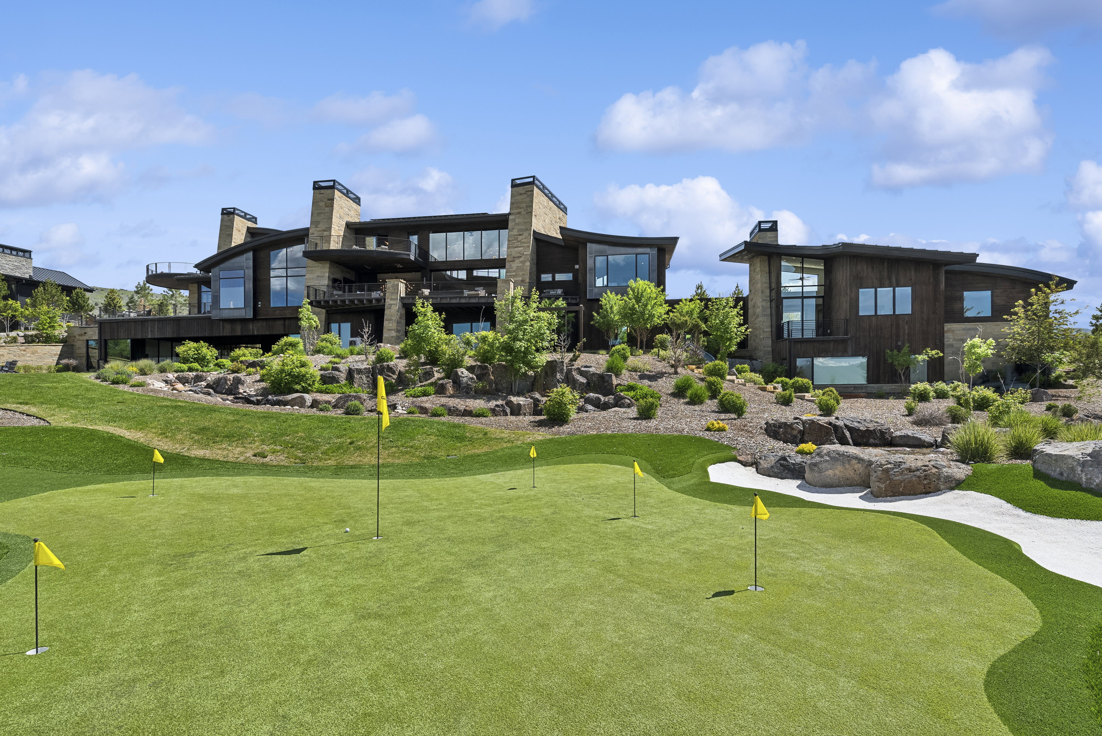 Expansive putting green with multiple holes and synthetic turf