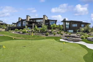 Expansive putting green with multiple holes and synthetic turf