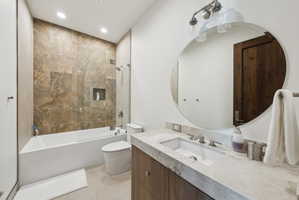 Contemporary bathroom featuring a built-in tub with a glass shower panel, an integrated shower niche, and extensive wall tiling