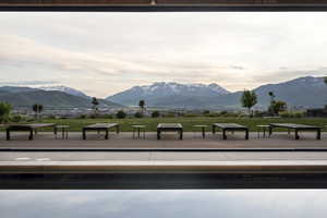 Infinity-edge pool overlooking a expansive landscape with distant mountains