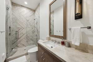Glass-enclosed shower with patterned tile walls and a built-in niche