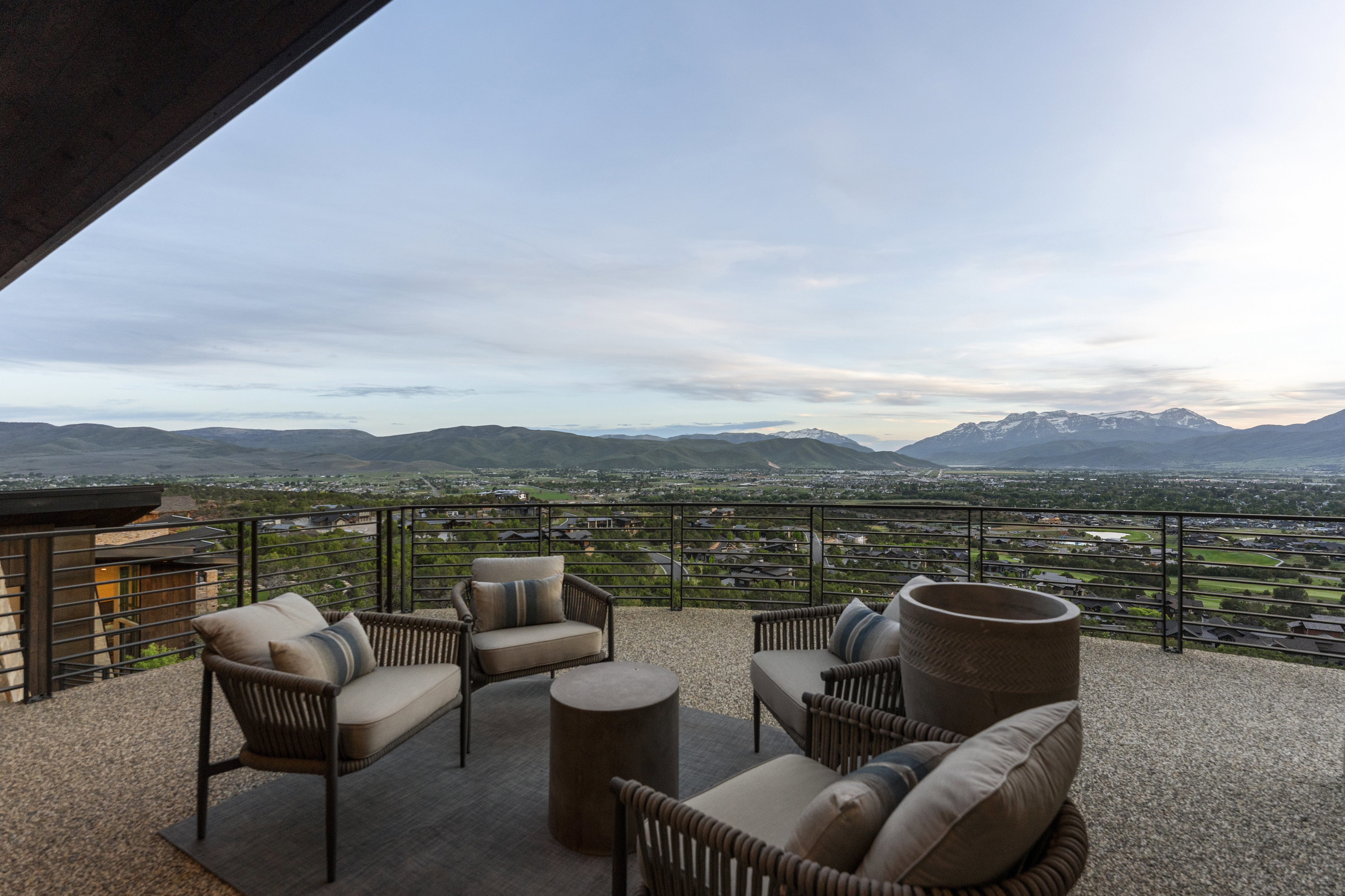 Expansive outdoor patio featuring an exposed aggregate surface and a perimeter railing