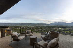 Expansive outdoor patio featuring an exposed aggregate surface and a perimeter railing