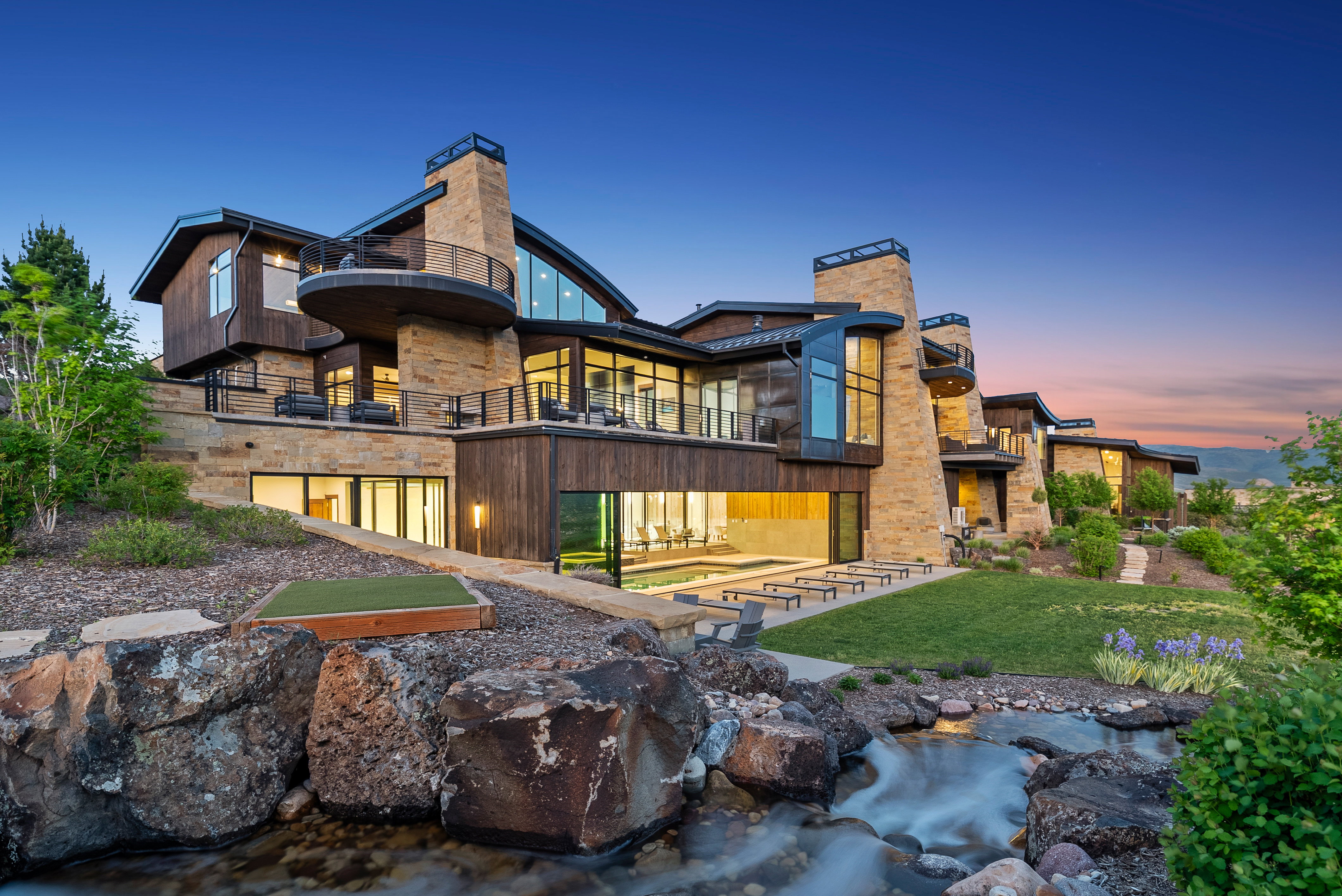 Multi-level contemporary residence featuring extensive stone and wood-finish siding