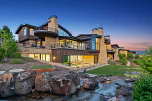 Multi-level contemporary residence featuring extensive stone and wood-finish siding