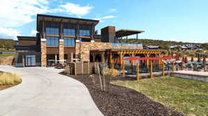 Contemporary multi-level building with stone and wood siding