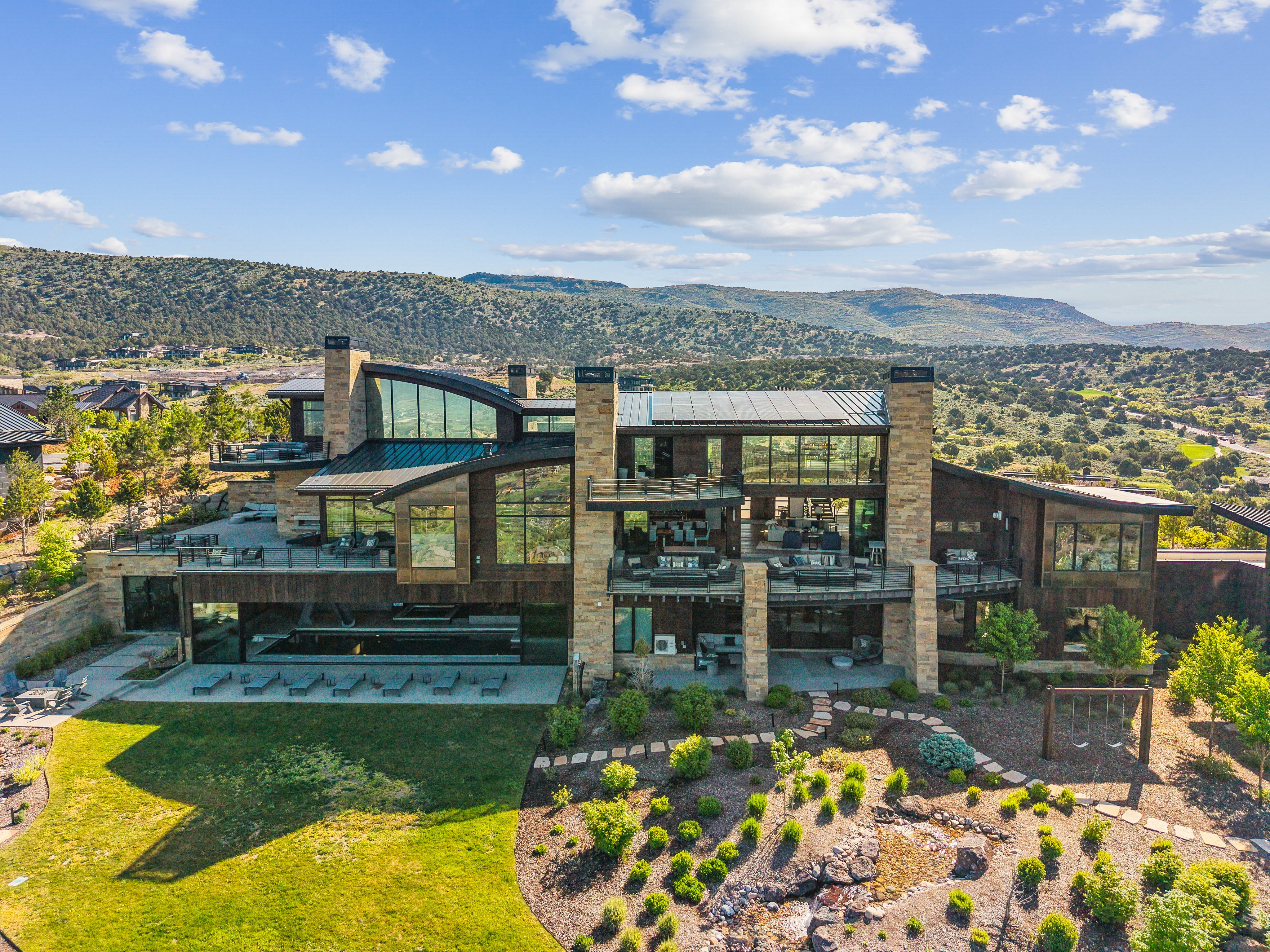 Expansive contemporary residence featuring multiple levels of outdoor living spaces