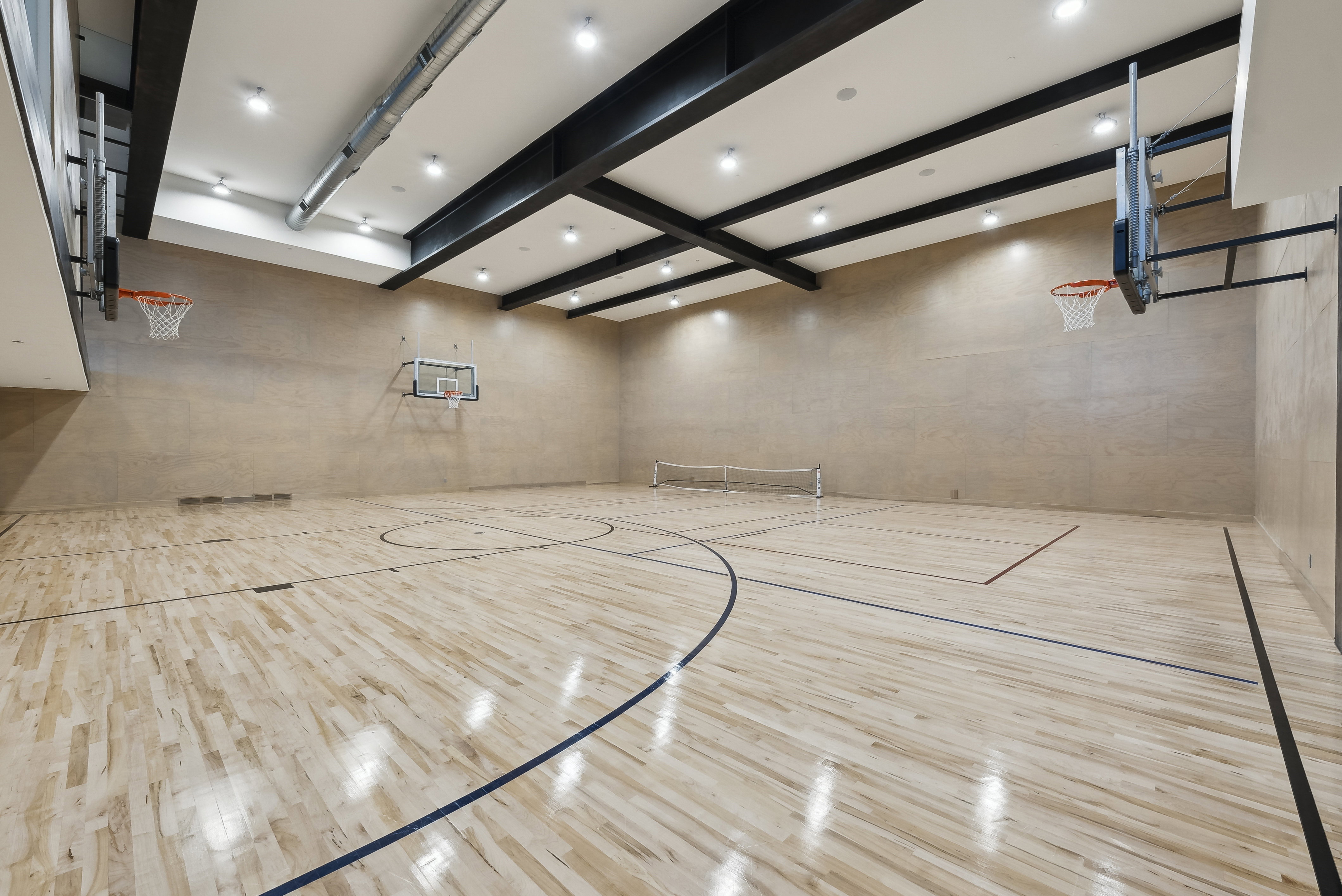 Indoor sports court featuring hardwood flooring with court markings